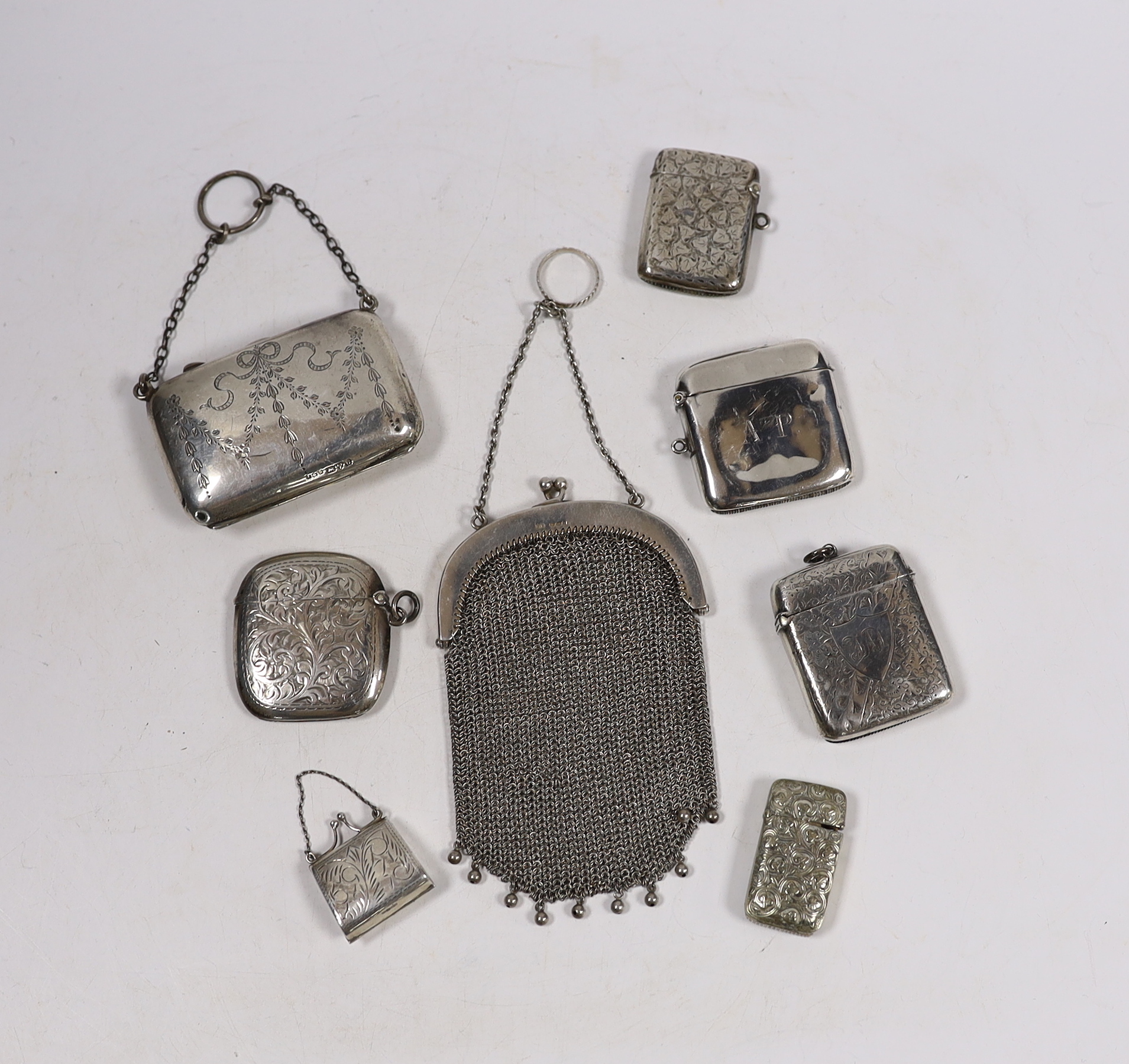 Four assorted early 20th century silver vesta cases and one base metal vesta case, two silver purses including mesh link and a small modern silver 'handbag' pill box.